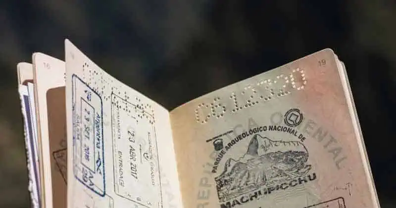 Reisdocument met stempel en handtekening op een vage achtergrond.